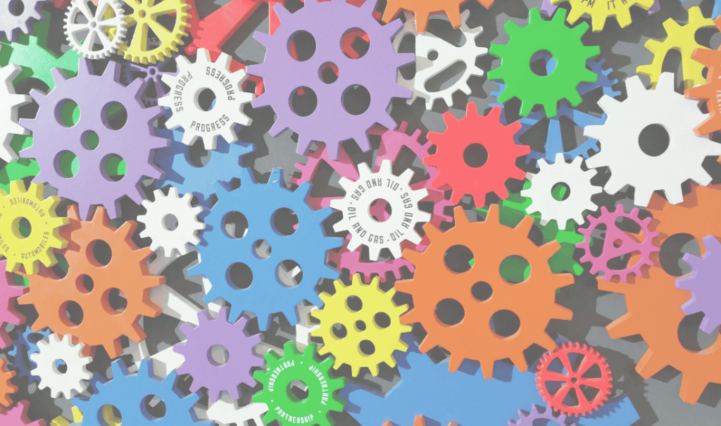 Fargerike tannhjul som symboliserer automatisering og prosesser som jobber sammen.